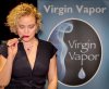 Annette Rogers, owner of Virgin Vapor, vapes while setting up the booth.jpg