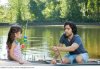 Father_and_daughter_on_rowboat_with_fishing_rods_IS098UP7Y.jpg