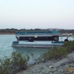 The Houseboat beached at Arkansas Park out on the lake.