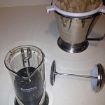 The Coffee Press loaded up, and the paper coffee filter in place in a strainer to do the second straining of the juice.
