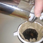 Pouring the NET juice into the paper coffee filter.