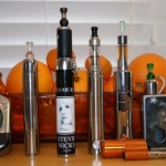 Fazed mod (Nivel chip), P18 (with an IGO-L on top), eVic with custom Jwrap and topped with a Vivi Nova tank, orange GLV Super Mini with Nano clearomizer, AltSmoke Omega with E1 tank, top feeder (with custom graphics) made by Shanmods and topped with another IGO-L.