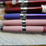 P1010042
Joye Tech Pink eGo starter kit (2 full e-cig sets).
plus 2 similar size batteries and other tops/cones.
Turkshead leather knots are my 'design' addition to the batteries 
(grin).
I also label the cartridge contents.