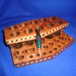 Notice the four holes on the second level for my 4 iTaste 3.0's. This side holds seven drip tips and 11 Kanger style clearos. Custom made for me by Wayne Church at http://www.customwoodpvecigholders.com/.
