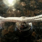 First coil. This is a 3/2 wrap with 32 Kanthal. The base sits in a Siam Mods base holder. Notice the wick sits above the airhole. The leads are easily connected with the two screws.