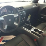 Hurst shifter with a short throw, MOPAR carbon fiber handle.