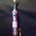 flashlight came with a "gripper" piece.  My husband modded it so that I could vape with it.  I added a CE2 with a pink aluminum drip tip, added a tiny big of bling around the top below the atty connector, and a cell phone charm on the bottom :)