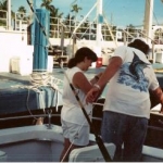 CAPTAIN BART & MY DAUGHTER
FEEDING THE TARPON & CATFISH 
AT THE CASTAWAYS DOCK, MIAMI BEACH, FL.