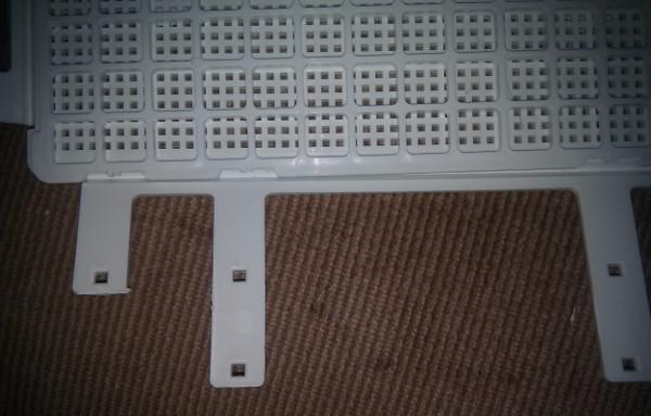 7: New bottom grid in place; now remove the excess side tabs. NOT with scissors - double ow! I used a Dremel.