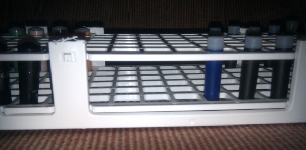 8: With new lower grid held just above bottom by the side tabs, the bottoms of carts can't slip sideways and nothing falls over.
