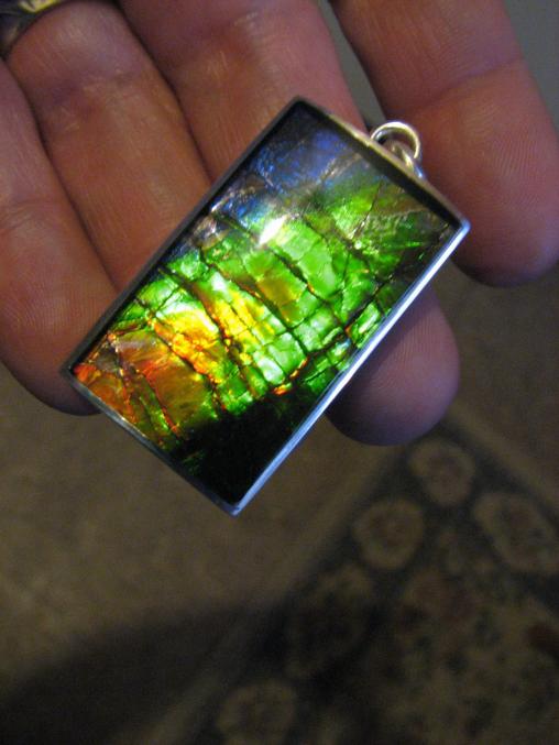 Ammolite Inlay with Sapphire cap.
