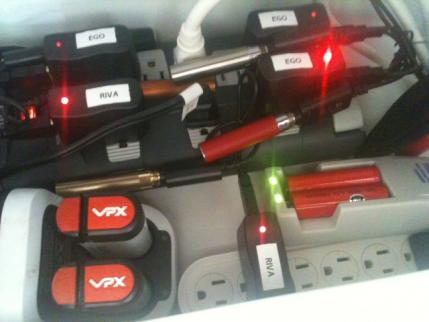 charging station 3:  some of the stuff i've fit in it.  i used a large surge protector and a small surge protector.  i have three eGo chargers, 2 riva 510 chargers, a black and decker vpx powerpak charger and the charger for the provari shown.  i have room for at least one more provari sized battery charger, and a couple of more smaller chargers.  sometimes i also charge my iphone here.