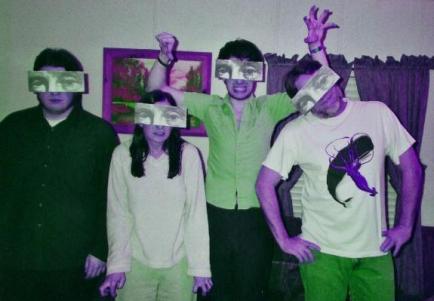 me & my family, back when i had hair. (& my now shaven headed son did too!) the masks were a gift from my friend in New Zealand. :-D
