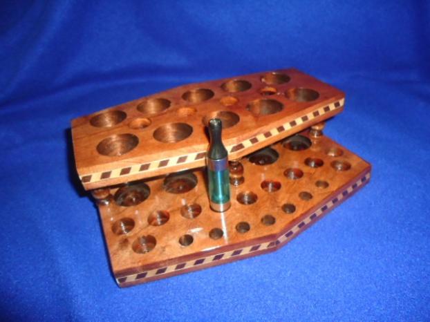 Notice the four holes on the second level for my 4 iTaste 3.0's. This side holds seven drip tips and 11 Kanger style clearos. Custom made for me by Wayne Church at http://www.customwoodpvecigholders.com/.