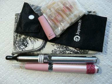 P1010045
My 2 carrying cases.
My 'go to' take alongs at bottom of pic.
A small zip-lock bag with filled carts for my pink original kit & used for the 'new juices' I am trying out (each cartridge is labeled with perm. marker on sides w/flavor and nic %/mg) cuz sometimes I want a stronger puff or two...