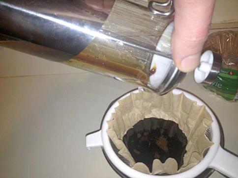 Pouring the NET juice into the paper coffee filter.