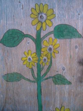 Shed door painted with sunflowers.