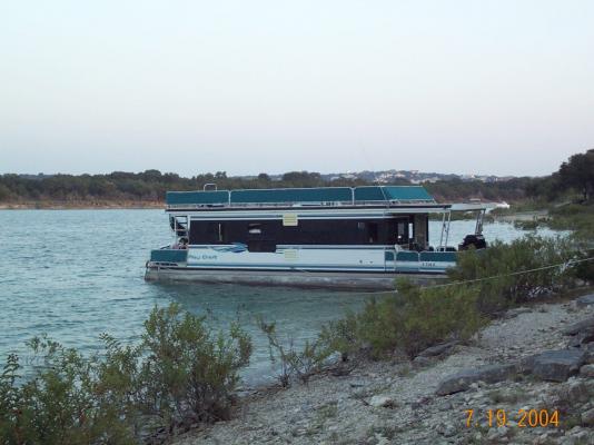The Houseboat beached at Arkansas Park out on the lake.