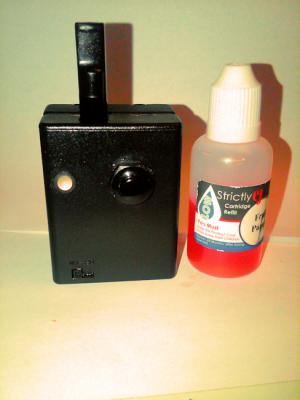 The Puck next to a 30ml Bottle of juice.