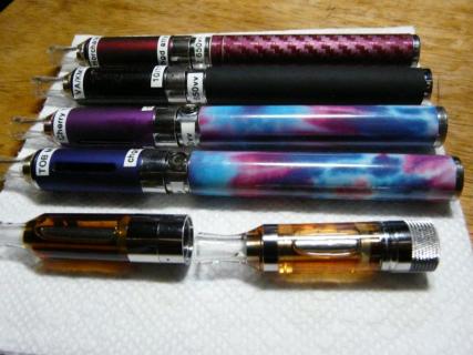 Three wrapped 650 Twist Bats and one black wrapped EVOD tank. 
In front are a 'clear EVOD-C' and a Fast Tech T32 clearomizer.