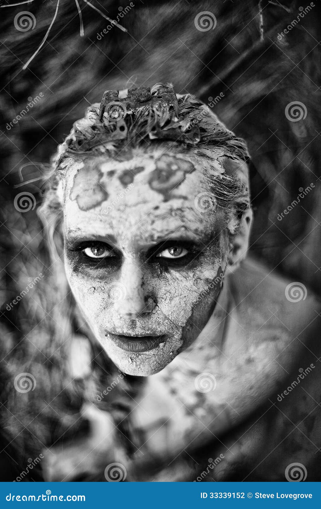 freaky-woman-face-covered-clay-staring-camera-33339152.jpg