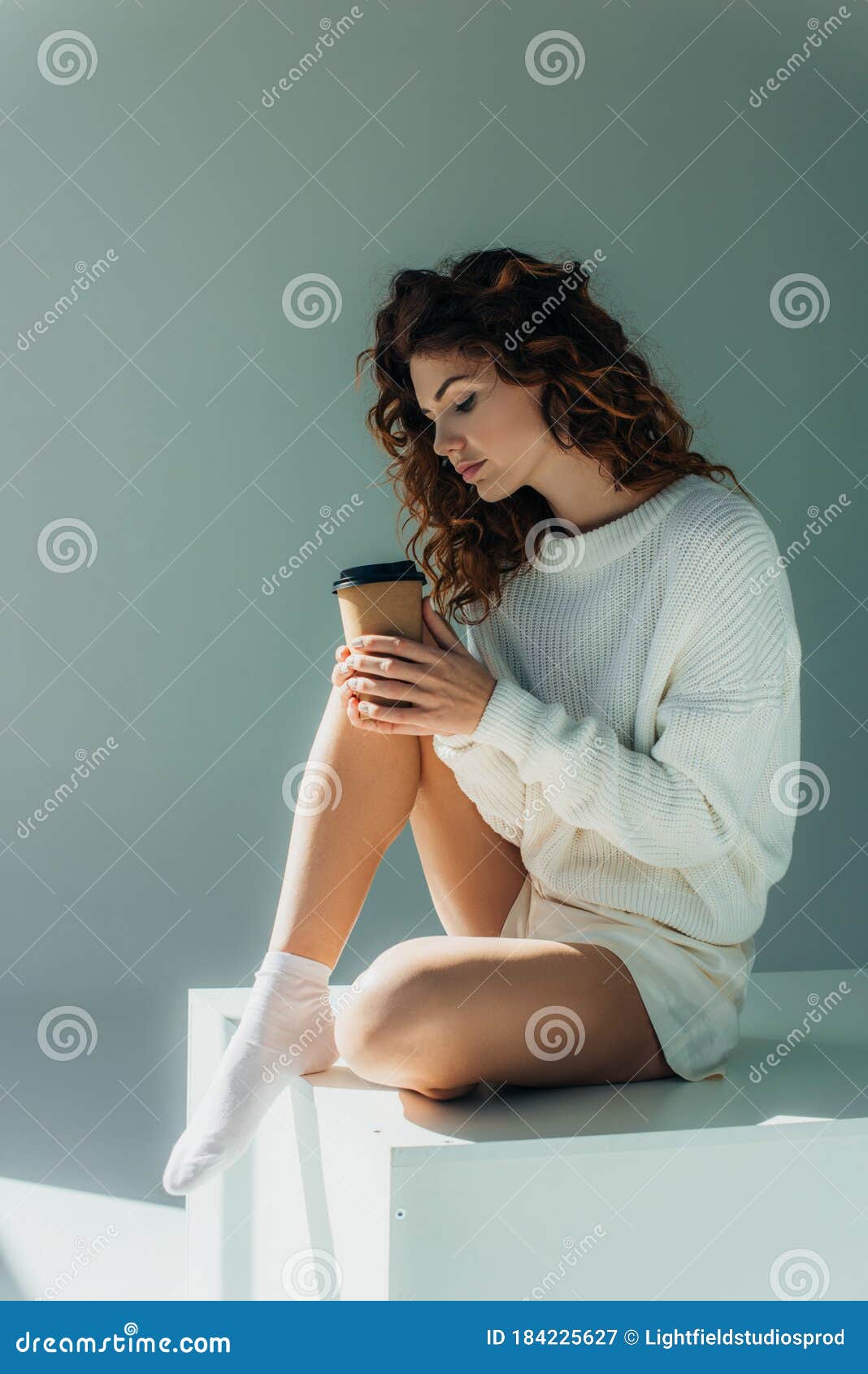 redhead-girl-looking-coffee-to-go-sitting-grey-curly-184225627.jpg