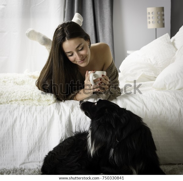 woman-drinking-coffee-her-dog-600w-750330841.jpg