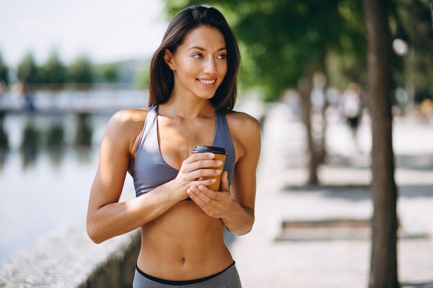 sporty-woman-drinking-coffee-park_1303-10140.jpg