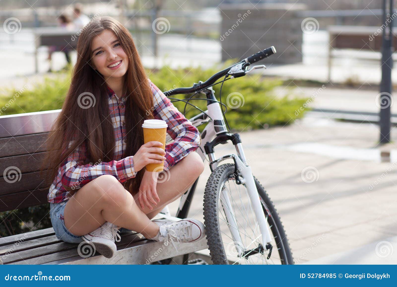 young-woman-drinking-coffee-bicycle-trip-52784985.jpg