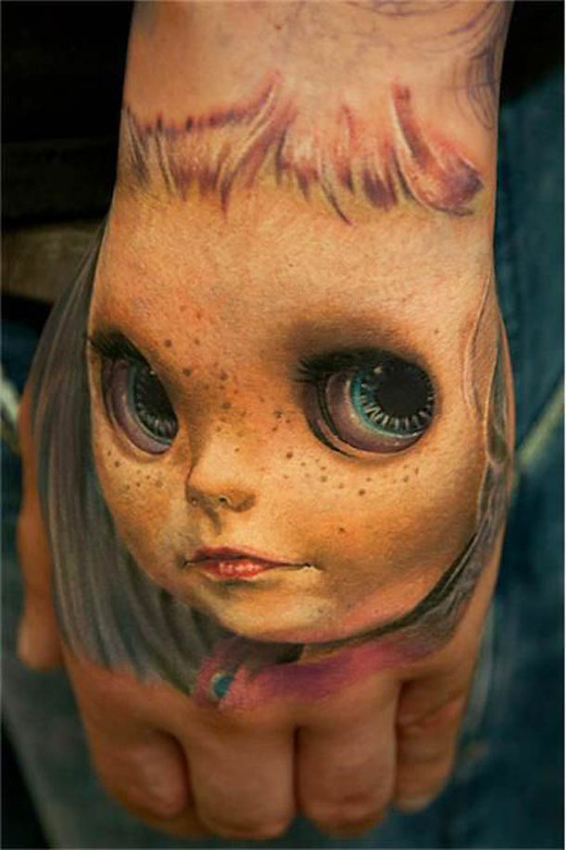 doll-head-hand-tattoo.jpg