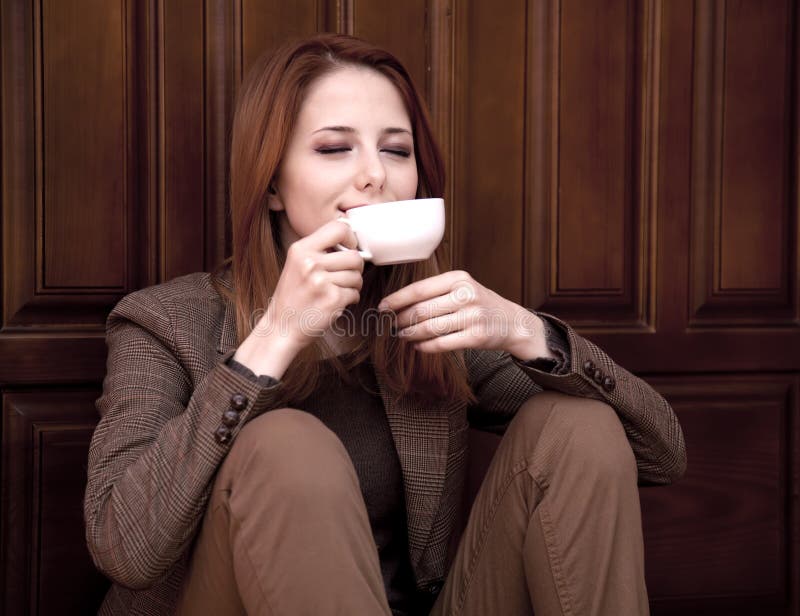 style-redhead-girl-drinking-coffee-22681100.jpg