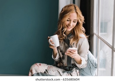 pretty-blonde-girl-sitting-on-260nw-635680604.jpg