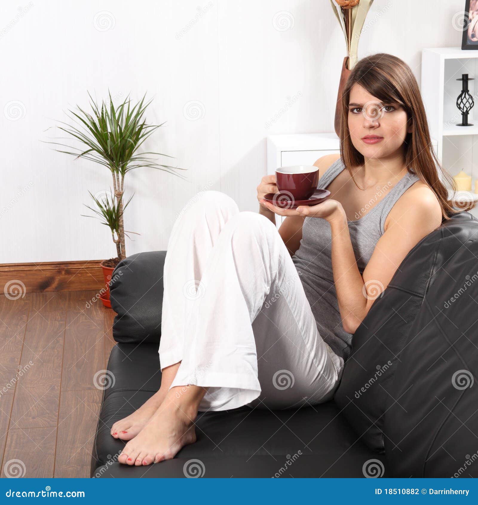beautiful-woman-home-sofa-drinking-coffee-18510882.jpg