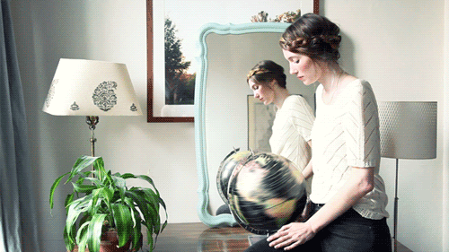 Animated-gif-of-woman-spinning-an-Earth-globe.gif