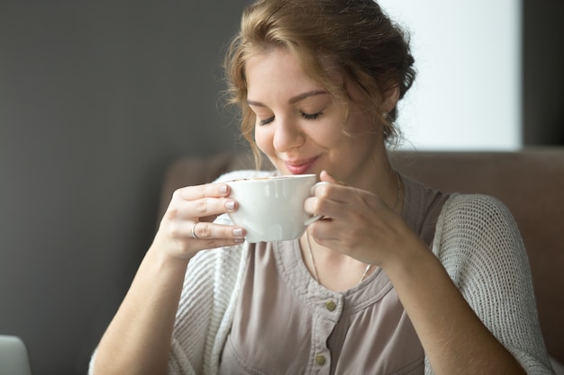 smiling-happy-woman-drinking-aromatic-coffee-with-closed-eyes_1163-1792.jpg