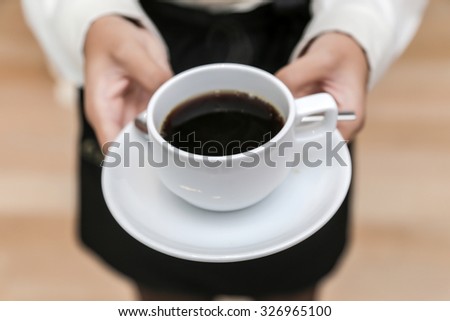 stock-photo-waitress-serving-coffee-cup-close-up-of-hand-showing-coffee-326965100.jpg